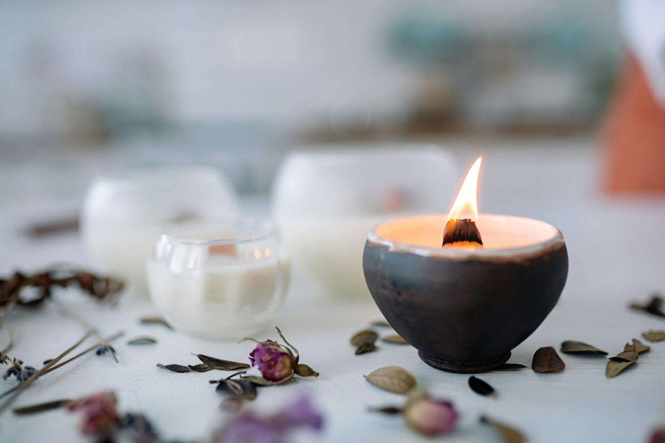 Candle and herbs showcasing an herbal ceremony event iin Manitoba Springs CO